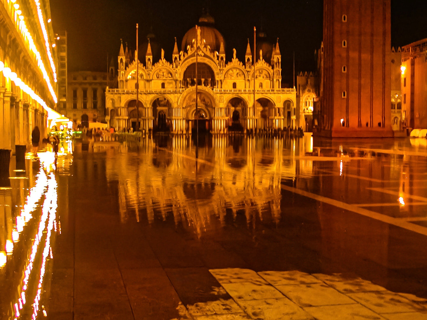 A Flooded St. Marks at Night - Fine Art Print captures St. Mark's Basilica and square in Venice, beautifully illuminated and reflected in floodwater, creating a stunning nighttime scene.