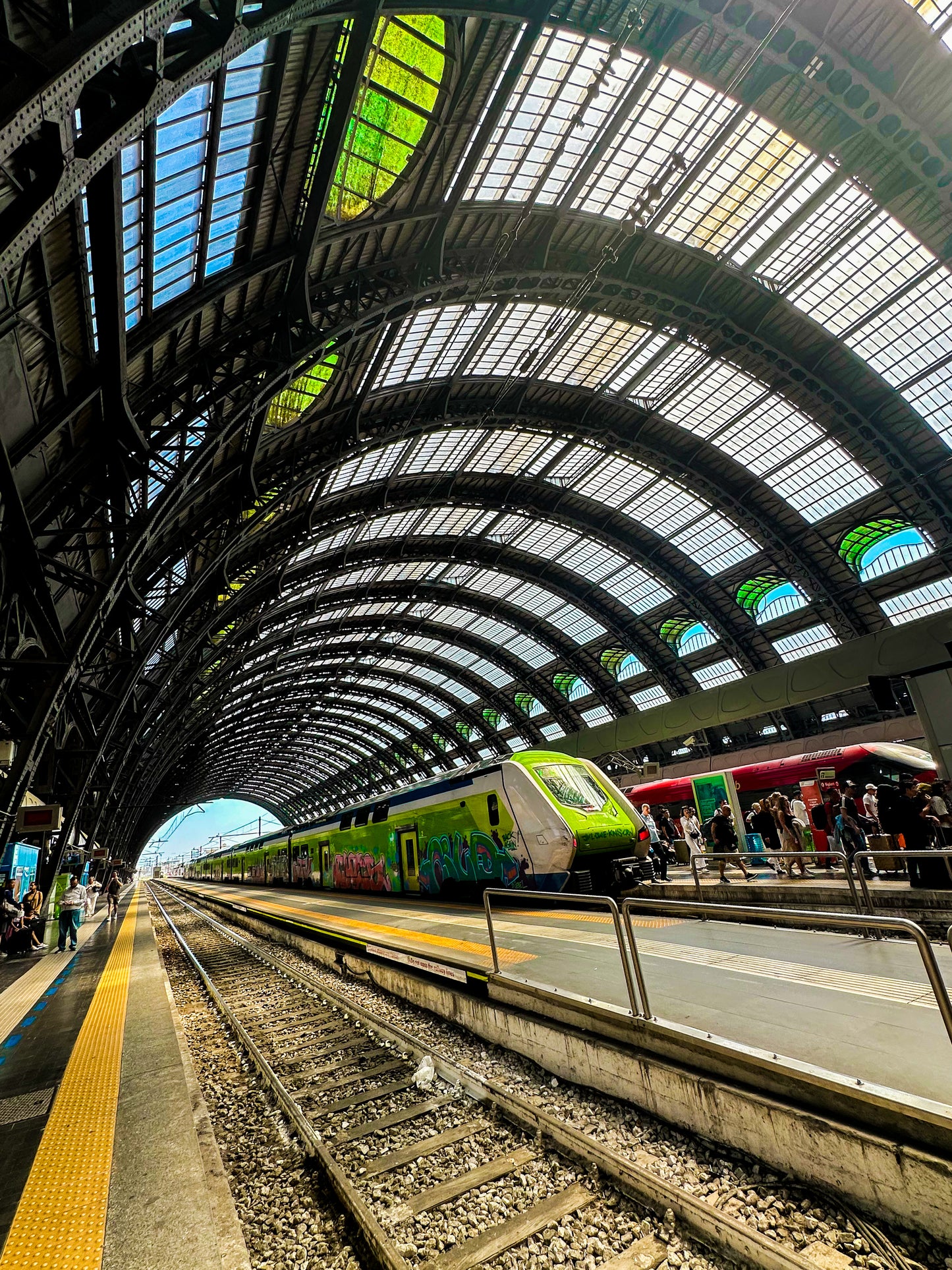 The "Milano Centrale - Fine Art Print" captures a modern train waiting at the platform under Milan Central Station's iconic arched glass roof, conveying the station's bustling energy.